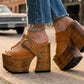Sol Caleyo handmade Western platform clogs in premium camel leather with 17cm wooden heel and antique-brass concho buckle details.
