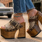 Sol Caleyo handmade Western platform clogs in exotic snake-print leather with 17cm wooden heel and antique-brass concho buckle details.
