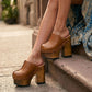 Brown leather clogs in a vintage 70s style. Super high vintage-style wooden heel. Sizes 33 to 47. High-end footwear handmade by Sol Caleyo.