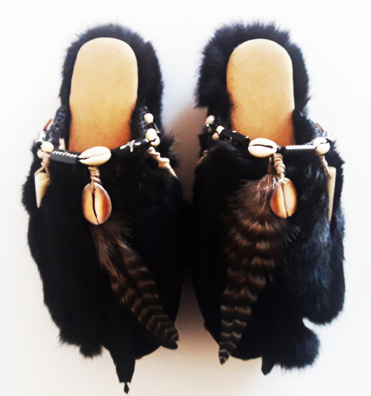Feathers, shells, bone and carved horn on boho platform clogs.