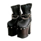 Handmade smooth black leather closed-toe platform ankle boots with silver pyramid studs, front chains and 15 cm wenge lacquered wooden heel by Sol Caleyo.