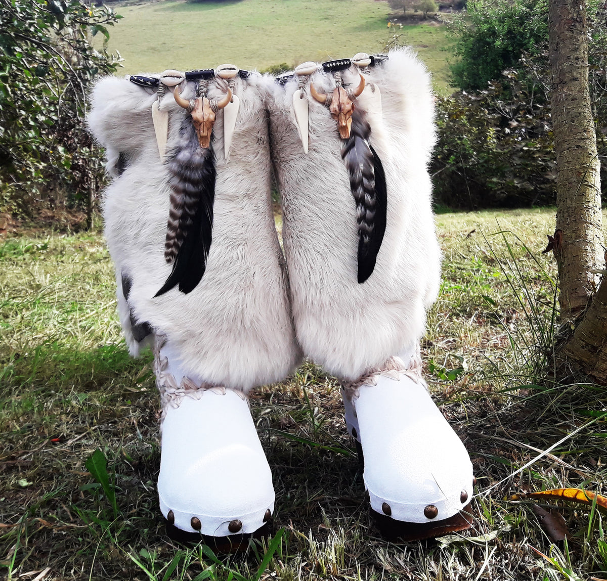 White handmade boho leather and rabbit fur wedge boots with carved bone, shells and feathers by Sol Caleyo
