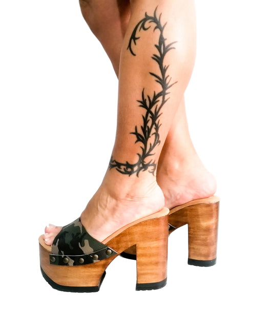 Handmade military green and brown camo print leather peep toe platform mule sandals with old-gold studs and 12 cm natural lacquered wooden heel by Sol Caleyo.