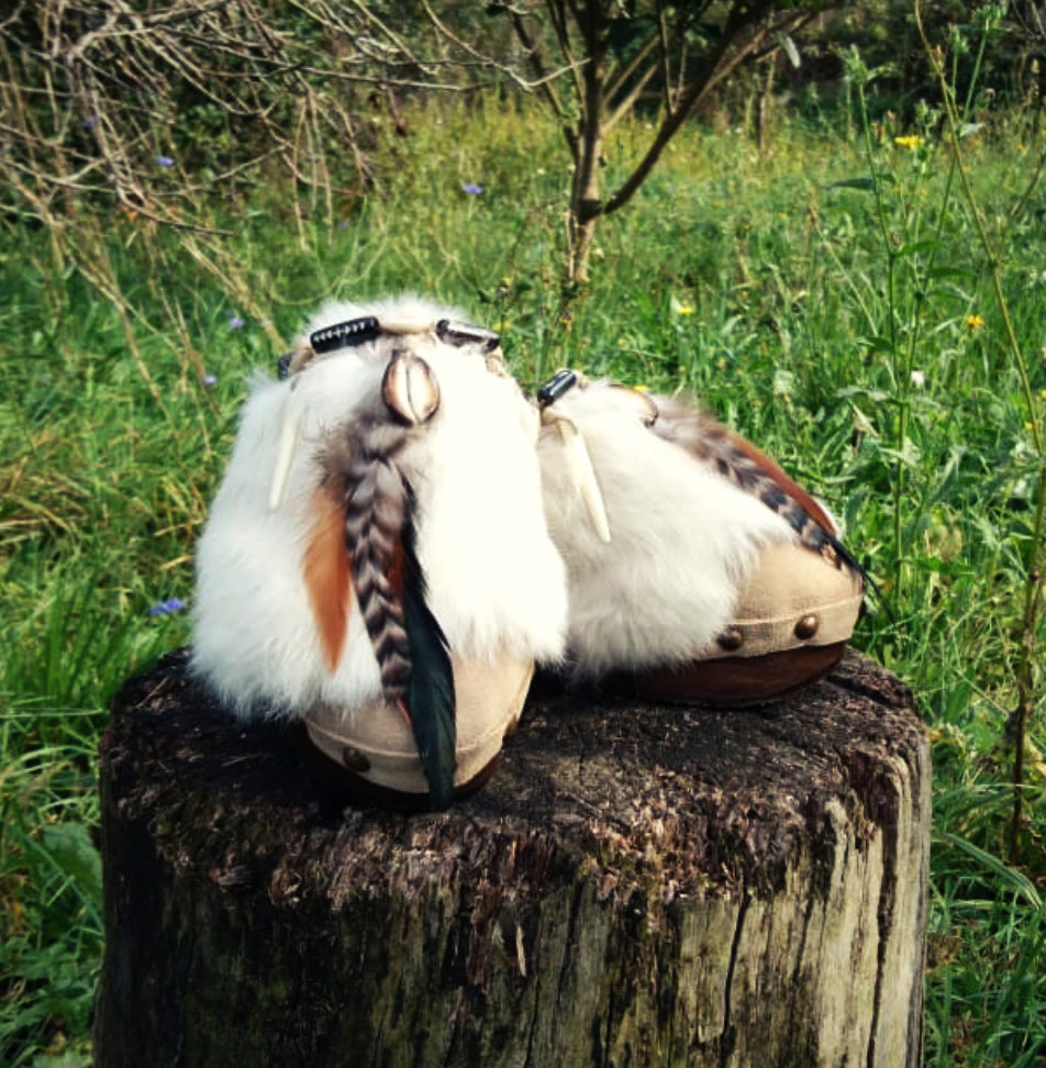 Feathers, shells, bone and carved horn on boho platform clogs.