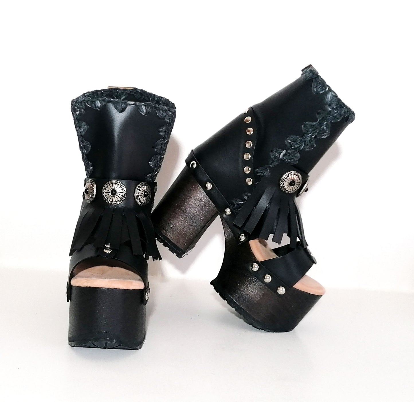 Black leather platform sandal. Leather boot with super high wooden heel. Black leather boot decorated with fringes and silver conchos. Bohemian style boots. Sizes 34 to 47. High quality leather shoes handmade by sol Caleyo. Sustainable fashion.