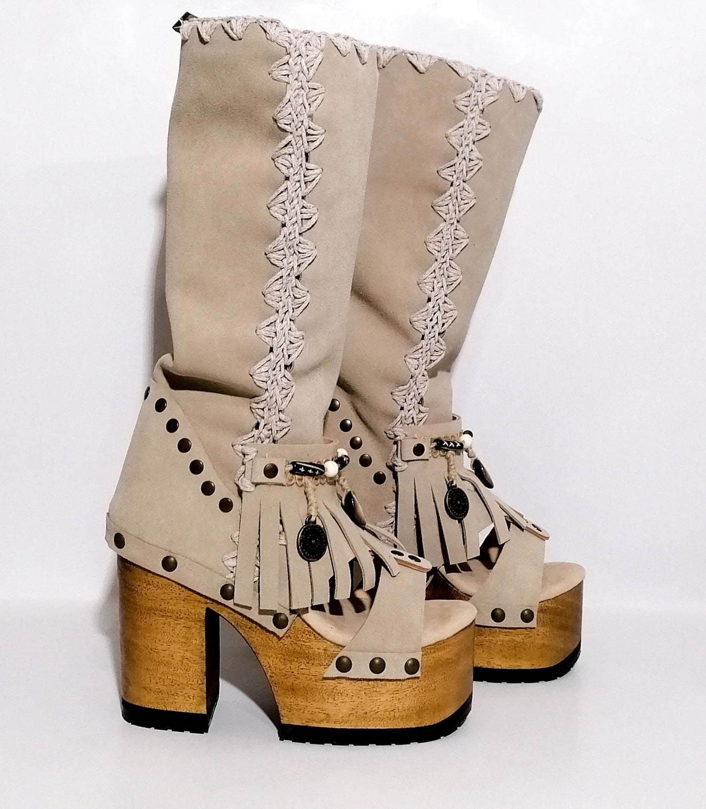 Vintage style wooden heeled clog boot. Suede leather boot decorated with fringes, natural shells, coins and carved bone with an authentic bohemian style. Boho style boots. Sizes 34 to 47. Handmade leather footwear by sol Caleyo.