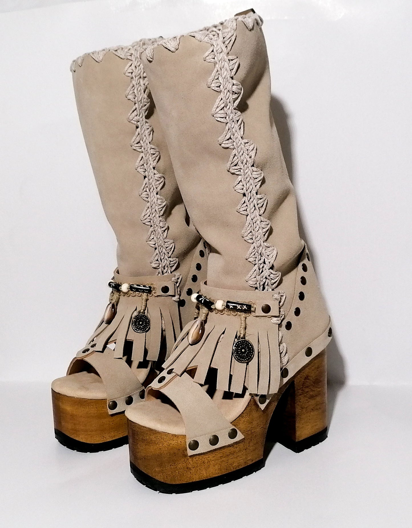 Vintage style wooden heeled clog boot. Suede leather boot decorated with fringes, natural shells, coins and carved bone with an authentic bohemian style. Boho style boots. Sizes 34 to 47. Handmade leather footwear by sol Caleyo.