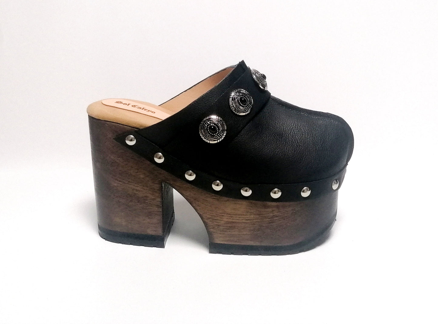 Vintage style black leather clogs. Super high heel clog decorated with vintage silver conchos. Bohemian style mule. Vintage 70's style platform clogs. Sizes 34 to 47. High quality leather shoes handmade by sol Caleyo. Sustainable fashion.