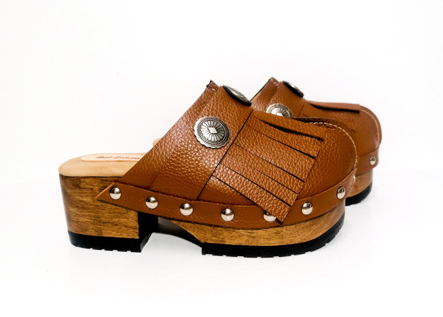 Brown platform clog vintage style 70s. Brown leather clog decorated with American Indian conchos. Leather clogs with wooden heel. Sizes 34 to 47. High quality leather shoes handmade by Sol Caleyo.