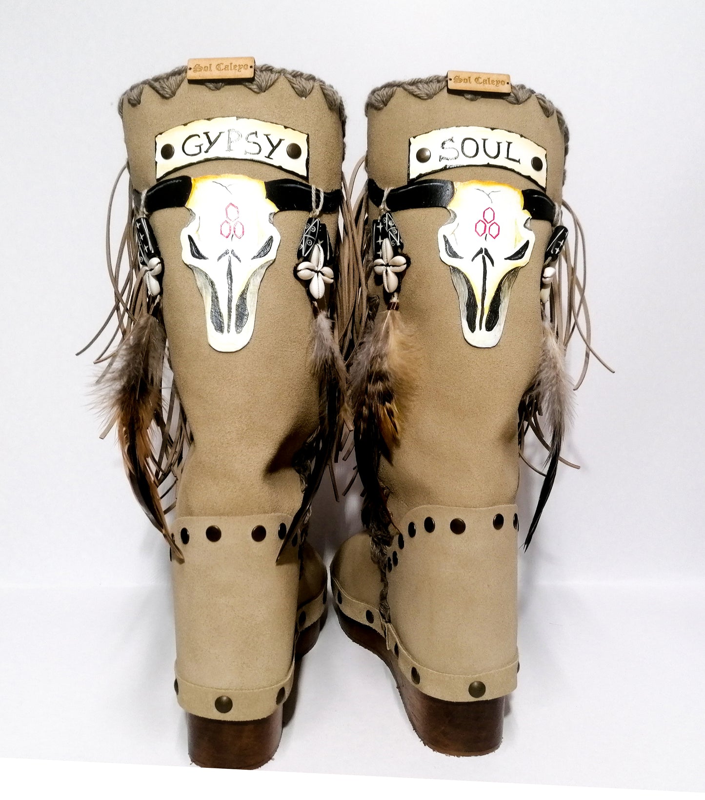 Wooden clog boot. Suede leather boot decorated with fringes, natural shells, feathers, horns and hand painted buffalo. Bohemian style boot with wooden wedge. Sizes 34 to 47. High quality leather footwear handmade by sol Caleyo. Sustainable fashion.