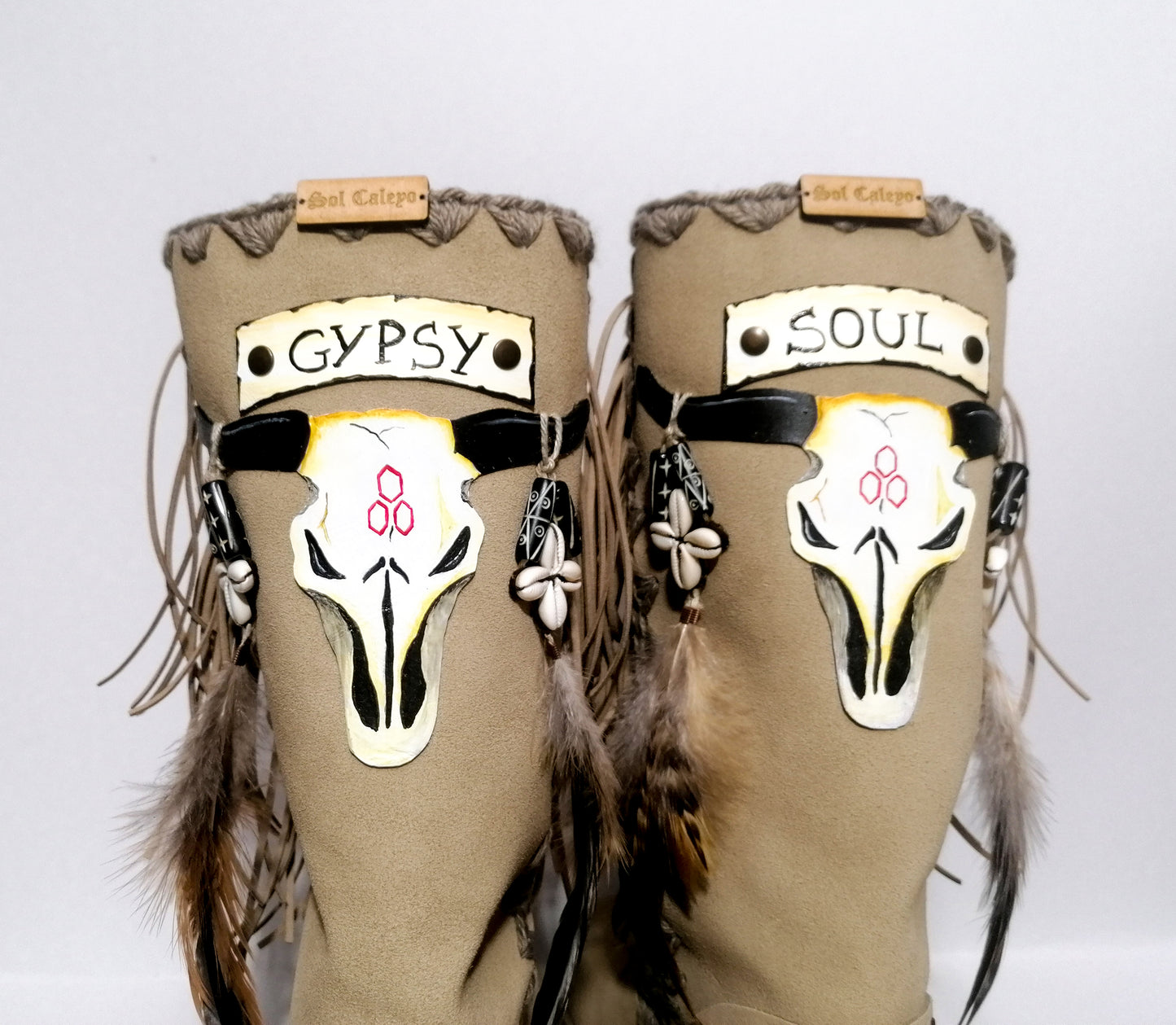 Wooden clog boot. Suede leather boot decorated with fringes, natural shells, feathers, horns and hand painted buffalo. Bohemian style boot with wooden wedge. Sizes 34 to 47. High quality leather footwear handmade by sol Caleyo. Sustainable fashion.