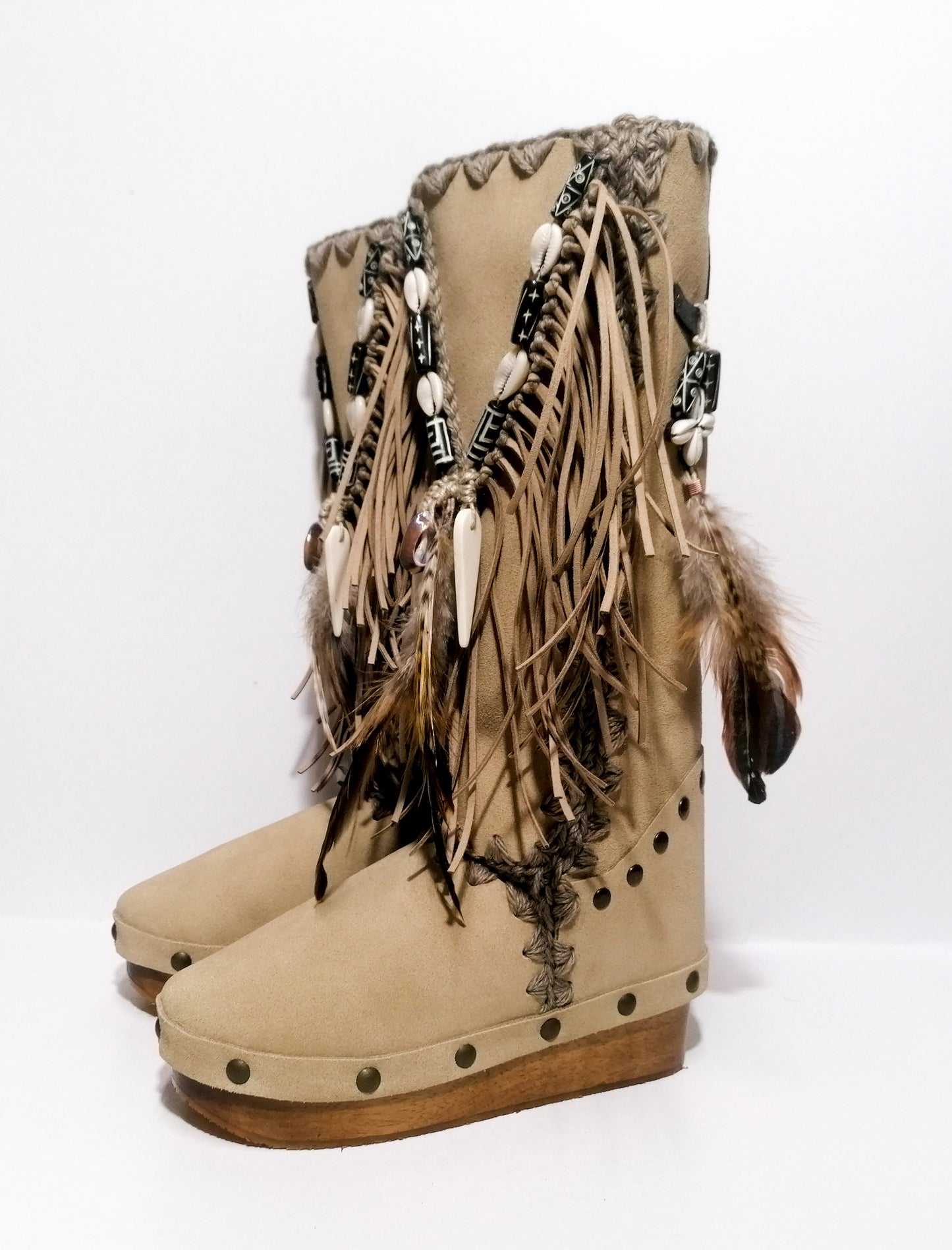 Wooden clog boot. Suede leather boot decorated with fringes, natural shells, feathers, horns and hand painted buffalo. Bohemian style boot with wooden wedge. Sizes 34 to 47. High quality leather footwear handmade by sol Caleyo. Sustainable fashion.