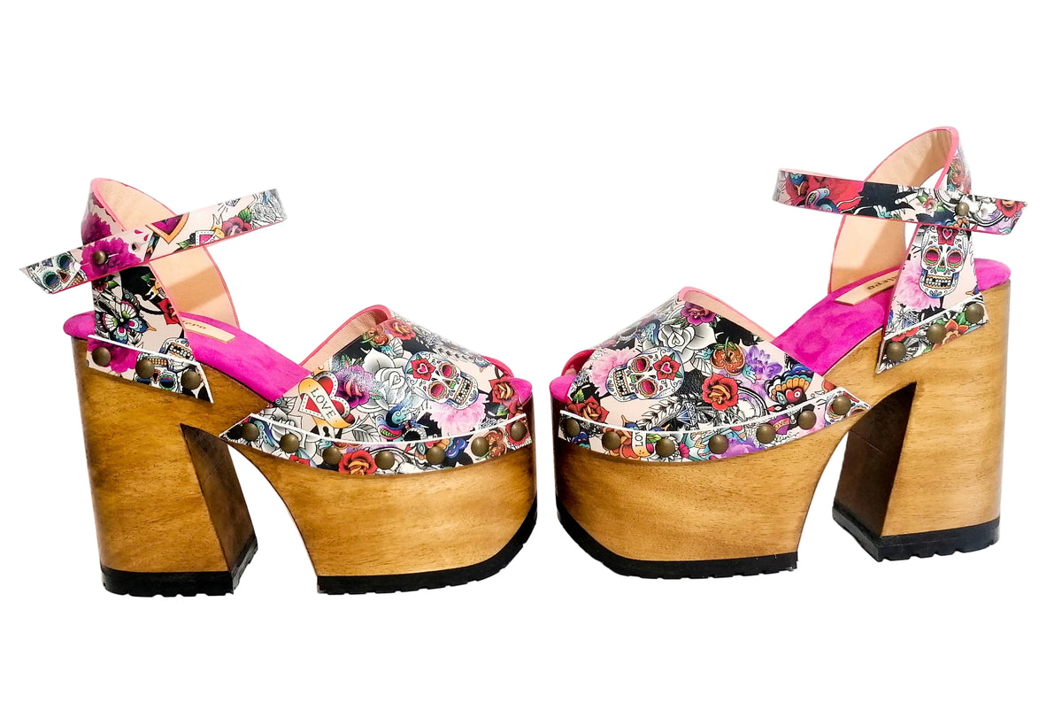 Ankle strap with button stud closure on pink tattoo print sandals.
