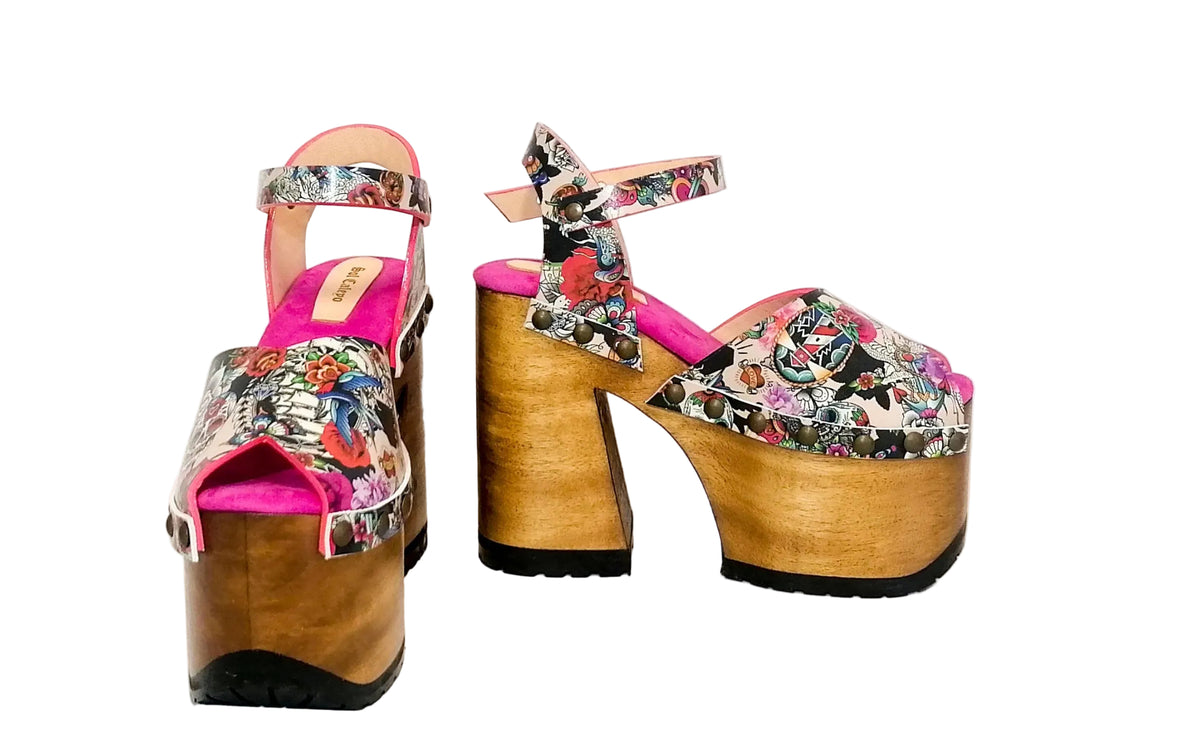 Pink tattoo print leather with skulls and roses on platform sandals.