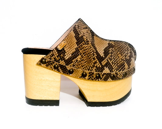 Handmade brown, beige and black snake embossed leather closed-toe platform mule clogs with round flat bronze studs and 10 cm natural lacquered wooden heel by Sol Caleyo.